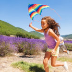 Girl running with kite - fun summer