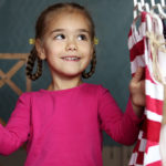 Young girl looking through her closet